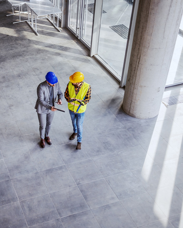 Two construction employees reviewing work